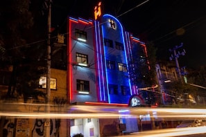 A building with a prominent 'H' logo, multiple windows, and a curved roofline. - Hotel Fabiola (Mexico City)