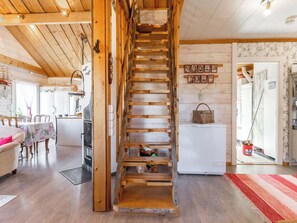 A rustic interior with a wooden staircase, a dining area, and a kitchen. - Keiteleen helmi by Interhome (Äänekoski)
