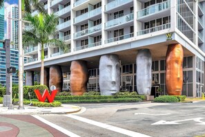 A modern hotel with a distinctive facade featuring large sculptural elements and a prominent 'W' logo. - 48th floor studio ★ Icon Brickell ★ (Miami)