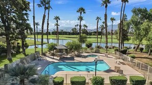 A pool area with a gazebo, lounge chairs, and a view of a golf course and lake. - Palm Springs Oasis w/Pool & Golf Access (Cathedral City)