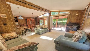 A cozy living room with a sofa, armchairs, and a dining area with wooden furniture. - Peaceful retreat above the Delaware River (Pond Eddy)