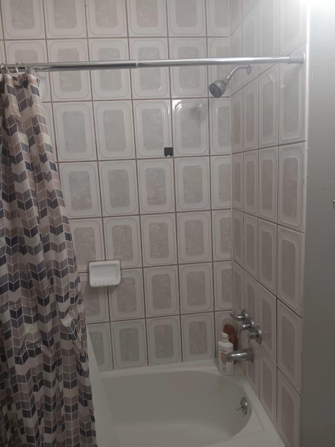 A bathroom with a shower, a bathtub, and a toilet.