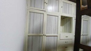A white wardrobe with multiple doors and drawers.