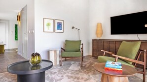 A modern living room with a flat-screen TV, two green armchairs, a coffee table, and a floor lamp. - Domaine De Cocagne N°3 - Pool & Sea View, Cagnes sur Mer, France (Cagnes sur Mer)