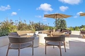 An outdoor seating area with wicker furniture and a large umbrella. - Domaine De Cocagne N°3 - Pool & Sea View, Cagnes sur Mer, France (Cagnes sur Mer)