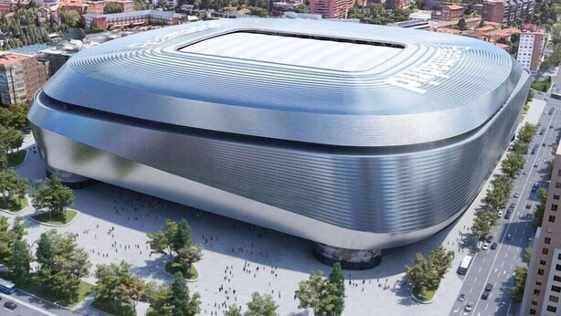 A modern, curved stadium with a large central field surrounded by seating. - Hostal Casa 18 (Madrid)
