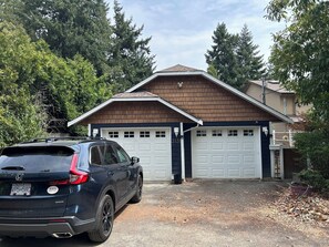 A residential garage with a dark-colored SUV parked in front. - Stay on Beautiful Glen Lake Victoria (Victoria)