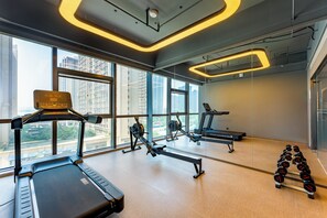 A gym with treadmills, rowing machines, and dumbbells, large windows, and a modern design. - Holiday Inn Express Nanjing Riverside (Nanjing)