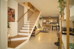 A modern interior with a staircase, a dining area, and a kitchen. - Corte Cavour in the City Center (Gallarate)