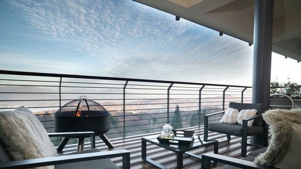 A balcony with a fire pit, seating, and a view of the landscape. - Da Gregorio: The Lake View Belvedere with Pools (Gignese)