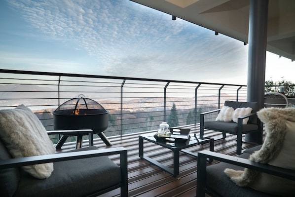 A balcony with a fire pit, seating, and a view of the landscape. - Da Gregorio: The Lake View Belvedere with Pools (Gignese)