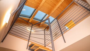 A modern interior with a wooden staircase, metal railings, and skylights. - Da Gregorio: The Lake View Belvedere with Pools (Gignese)