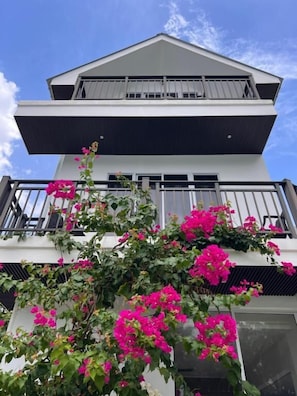 A two-story building with a balcony and a window.