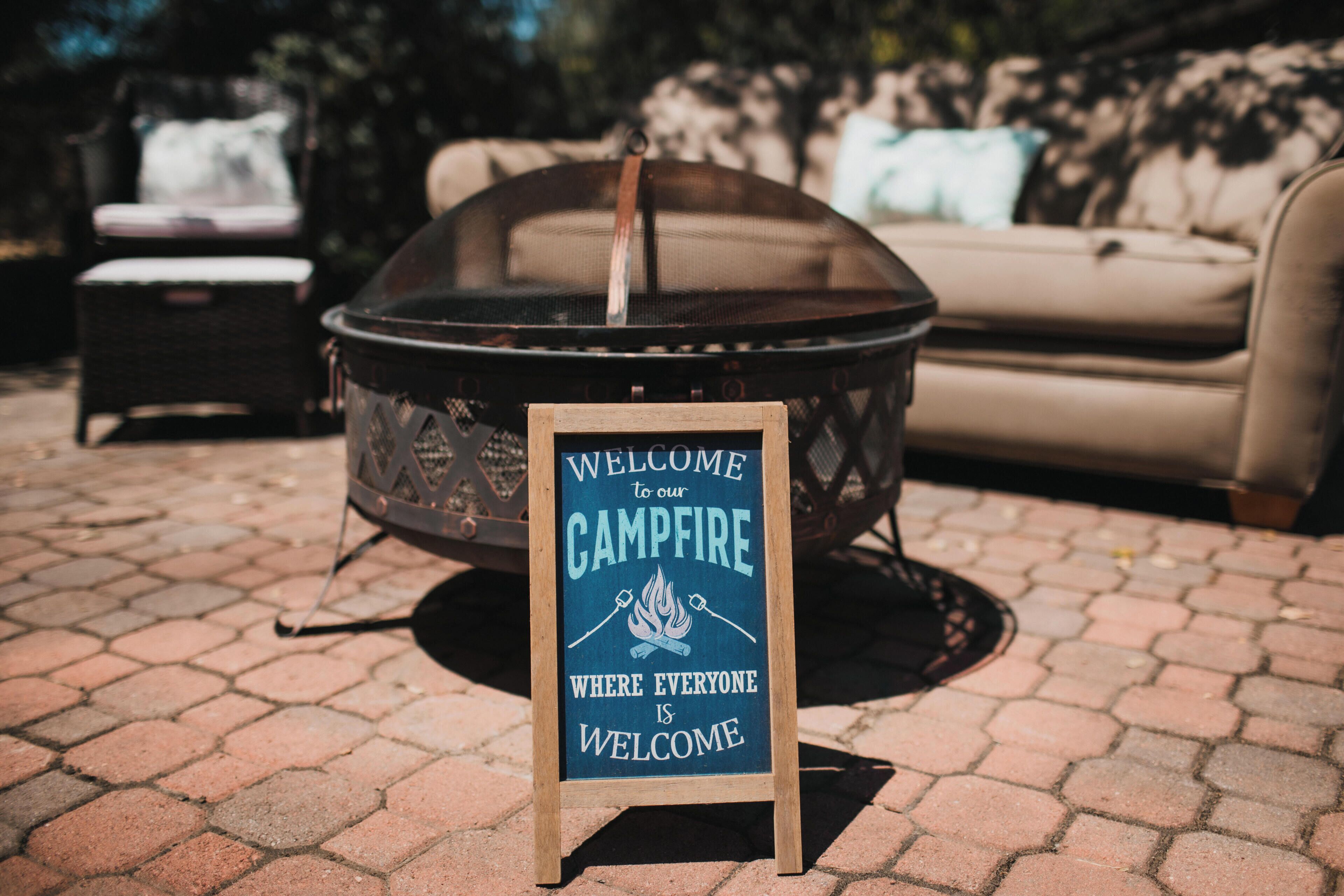 A campfire sign with a message welcoming everyone to the campfire area.