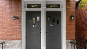 A double door with '2710B' and '2710A' signs, a mail slot, and a small window on each door. - Chic 2bd/Free parking/Nr Arpt/Nr Downtown/Firepit (St. Louis)