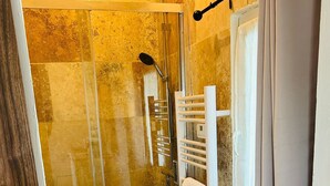 A bathroom with a glass-enclosed shower, a white sink, and a towel rack. - Couples getaway with pool and pool house (Arles)