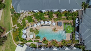 An aerial view of a resort with a central pool, multiple lounge areas, and a landscaped garden. - Resort Apartment 5302 at Gunnamatta Avenue (Kingscliff)