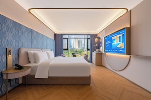 A modern hotel room with a large bed, a television, and a view of the cityscape. - Manxin Hotel Chengdu Taikoo Li JiuyanBridge (Chengdu)