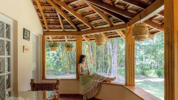 A room with a wooden ceiling, large windows, and a view of the outdoors. - Coffee Cottage by Raho Stream View Estate Escape (Coorg)