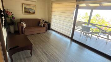 Deluxe Apartment, Balcony, Sea View | Living area