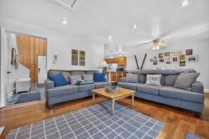 A modern living room with a grey sofa set, a wooden coffee table, and a patterned rug. - Ski Getaway + Indoor Pool + Full Kitchen | North Creek, NY | Uncas (North Creek)