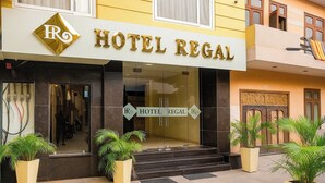 A hotel entrance with a sign reading 'HOTEL REGAL,' a logo with 'R' and 'O,' and a staircase leading to the entrance. - Hotel Regal (Amritsar)