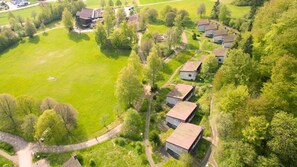 Un quartier résidentiel composé de plusieurs maisons individuelles, d’un grand espace vert et d’un sentier sinueux.