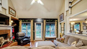 A living room with a fireplace, a sofa, a bench, and a rocking horse. - On Horse Farm! Home w/ Gazebo in Aiken (Aiken)