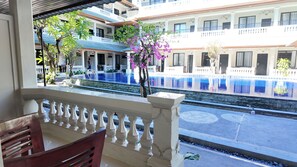A hotel with a pool, balconies, and a view of the pool area. - Mysa Hotel and Co Living (Kuta)