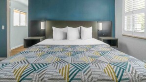 A bedroom with a bed, nightstands, a headboard, a window with blinds, and a door. - 1 King Bed|Nsmk, Kitchen (Madera CA)