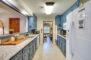 A kitchen with blue cabinets, a white refrigerator, and a wooden countertop. - Hot Tub & Game Room! Home 15 Mi to AT&T Stadium (Fort Worth)
