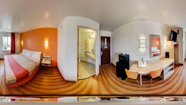 A hotel room with a bed, bedside table, lamp, and a desk with chairs. - 1 King Bed|Mobility|Tub,Nsmk (El Reno)