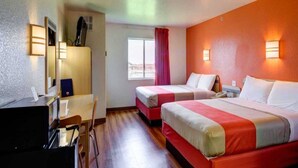 A hotel room with two beds, a desk, a chair, a window with a red curtain, and wall-mounted lights. - 2 Queen Beds|Non-Smoking (El Reno)