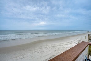 A beach view with a wooden railing, sandy beach, and ocean. - Sun, Sand, Poolside Vibes! Daytona Shores Retreat (Daytona Beach Shores)