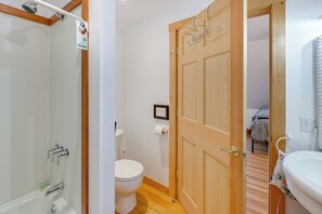 A bathroom with a shower, toilet, and sink. - Waterfront Maine Hideaway: 14 Mi to Quoddy Head (Lubec)