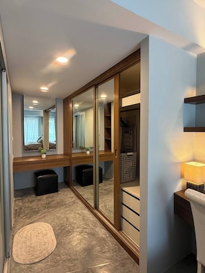 A modern room with a sliding closet, a desk with a lamp, and a small rug. - Stylish Loft Apartment Near Fisherman’s Village (Bo Put)