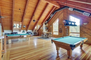A wooden interior with a pool table, ceiling fans, and a dining area. - Fairways, Fishing & Forest Fun! Show Low Retreat (Show Low)
