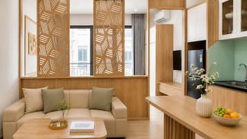 A modern living room with a sofa, coffee table, and a decorative partition.