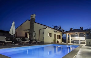 A swimming pool with lounge chairs, a covered patio, and a building with a chimney. - Amazing home in Sapjane (Sapjane)