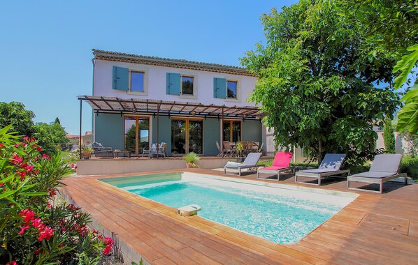 A two-story house with a swimming pool, outdoor seating, and a pergola. - Bastide Néo Provencale (Grignan)