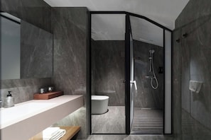 A modern bathroom with a glass-enclosed shower, a white bathtub, and a vanity with a marble countertop. - Luoyang Yunhuali Hotel (Luoyang)
