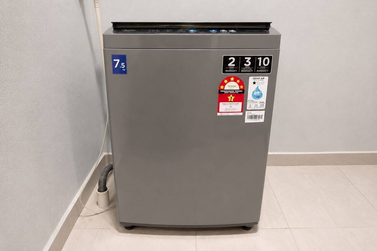 A compact, grey, wall-mounted air conditioner with a digital display, a water conservation sticker, and a CEAP air certification label.