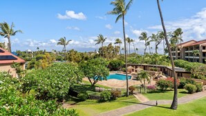 A resort with a swimming pool, palm trees, and a building with a red roof. - 2BR, 2BA Kaanapali Royal condo with pool, hot tub, kitchen, AC-Kaanapali Royal F302 (Lahaina)