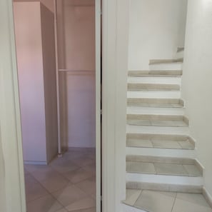 A staircase with multiple steps leading upwards, a door frame, and a tiled floor. - Villa Relax hot tub with panorama, about m. 300 from the beach (VILLASIMIUS)