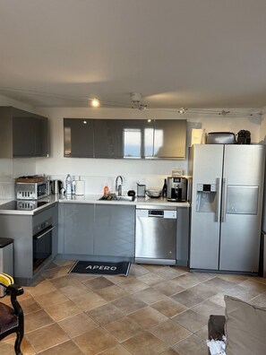 A modern kitchen with stainless steel appliances, a dishwasher, and a coffee machine. - Beautiful Mazet in Pramousquier, Le Lavandou, with Terrace, 3 Bedrooms Sea View. (LE LAVANDOU)