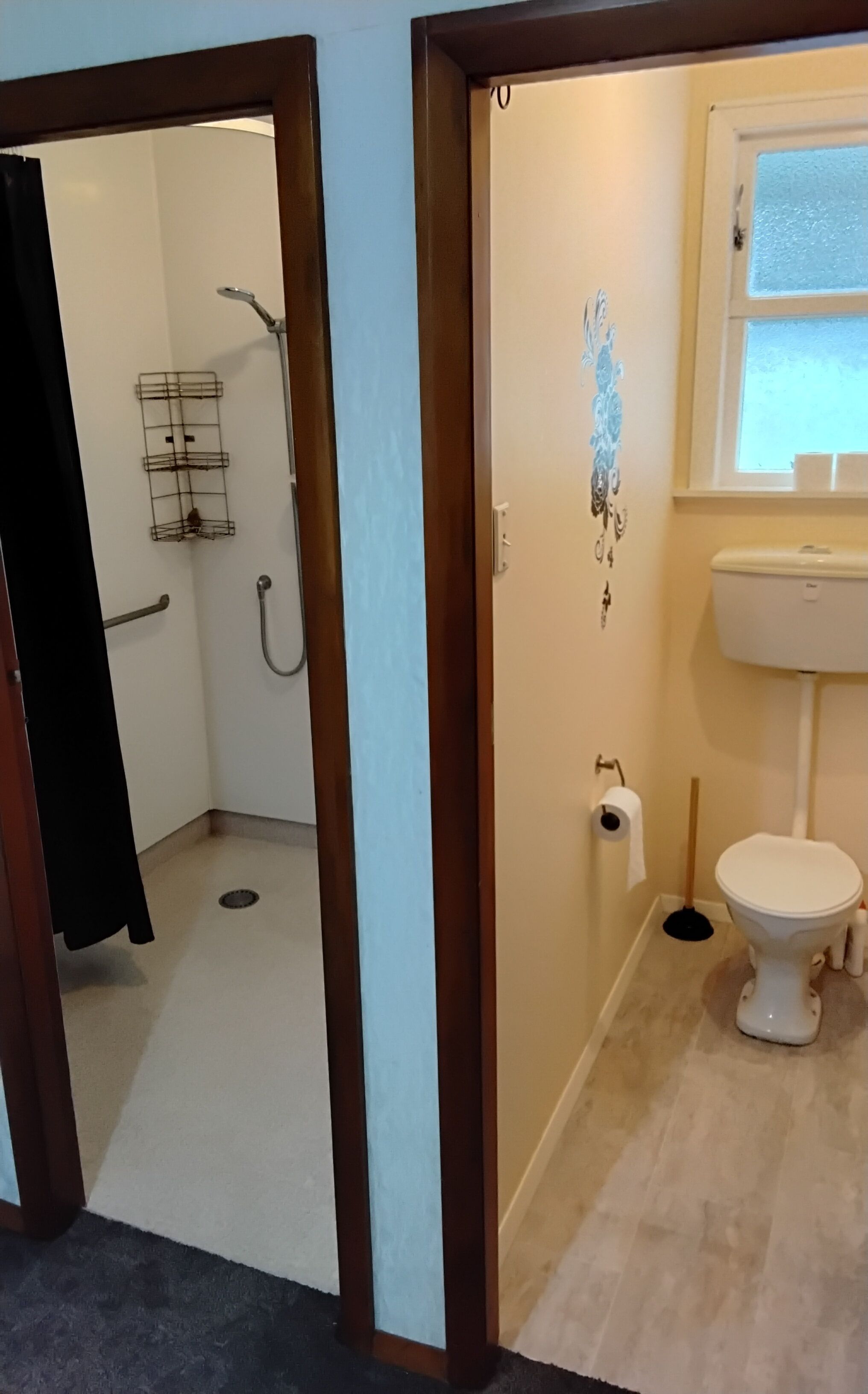 A bathroom with a toilet, sink, and shower.