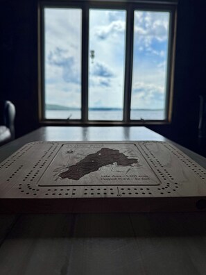 A wooden board with a map and text detailing Lake Area and Deepest Point.
