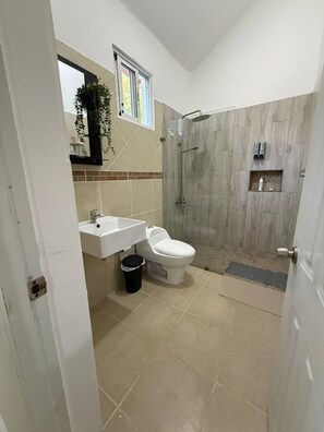 Ein Badezimmer mit Toilette, Waschbecken und Dusche.