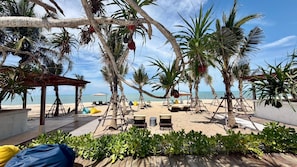 A beachside lounge with wooden deck, lounge chairs, and a view of the sea. - SUNRIO BEACH HOTEL SICHON (Sichon)