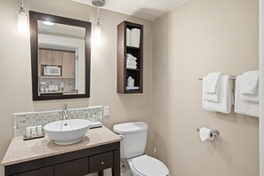 A bathroom with a white sink, a toilet, a towel rack, and a mirror. - Studio in Elation at Sandestin Golf and Beach Resort! (Miramar Beach)